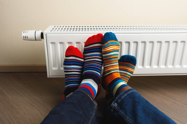 lábak színes zoknit a fűtőtest előtt - Fotó, kép