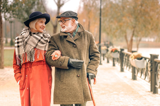 Elderly couple taking a walk in park - Φωτογραφία, εικόνα
