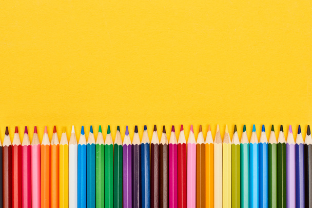 Bright color sharpened pencils isolated on yellow - Foto, Imagem