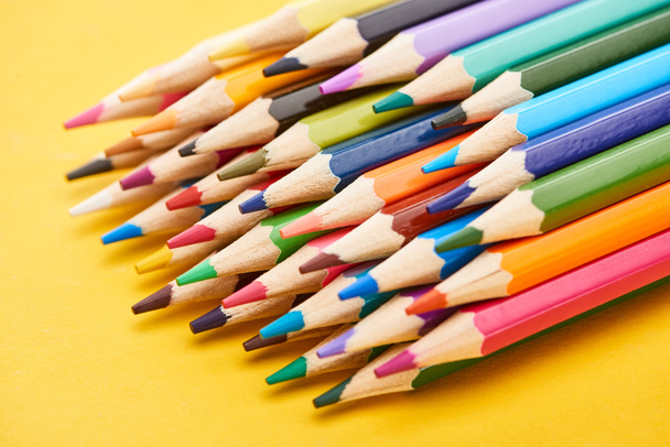 Set of sharpened color pencils on yellow background - Foto, afbeelding