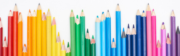 Panoramic shot of line of different sizes color pencils isolated on white - 写真・画像