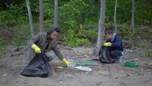 volunteers with garbage bags cleaning forest - Footage, Video