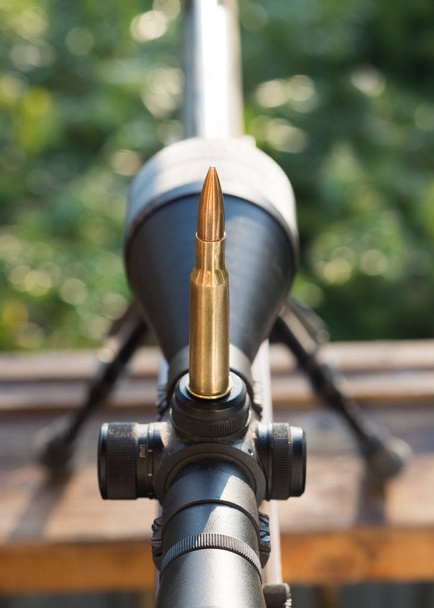 Cartridge on rifle scope. Close up photo. - Photo, Image