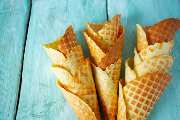 waffle cones on turquoise wooden surface - Photo, image