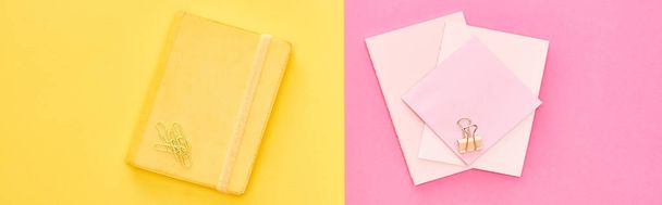Πανοραμική βολή από κίτρινο σημειωματάριο και ροζ φύλλα χαρτιού σε διχρωματιστό φόντο - Φωτογραφία, εικόνα