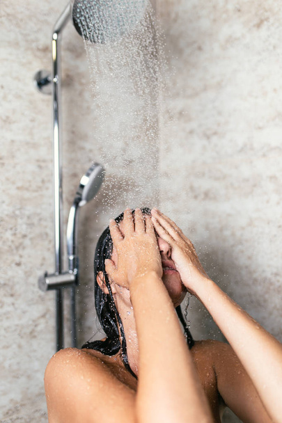 Beautiful woman taking shower in her bathroom. - Fotó, kép