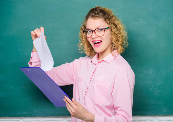 Read impressing resume. Tutor checking homework. Woman smart lady hold tablet documents. Read personal profile. Estimate essay of applicants. School project. Literature teacher read composition - 写真・画像