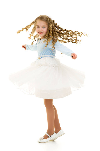 A little girl in a dress is spinning. - Fotografie, Obrázek