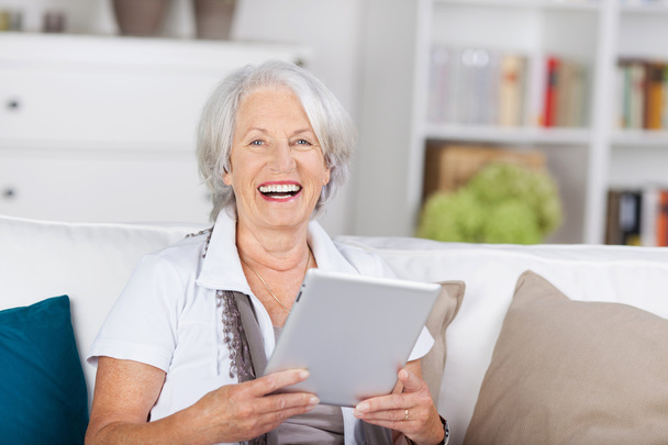 Laughing beautiful senior with a tablet-pc - Foto, Imagem