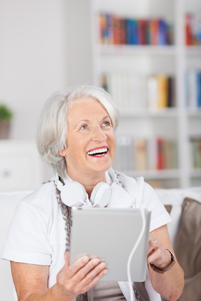 Modern senior woman with headphones and a tablet - Φωτογραφία, εικόνα