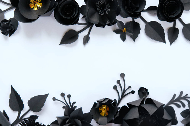 Black paper flowers on white background. Cut from paper. - Foto, Imagen