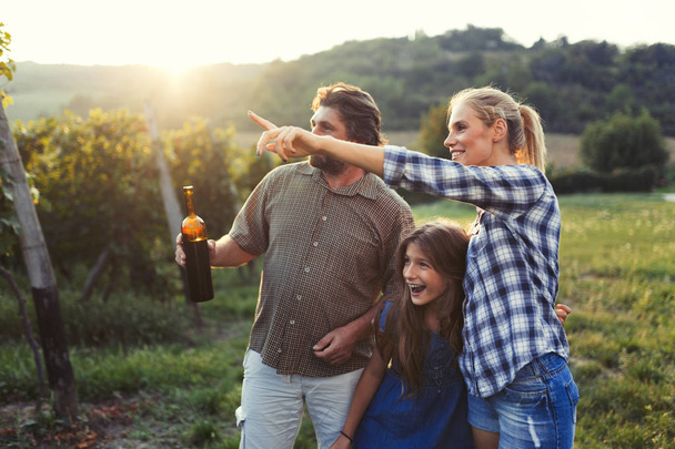 Picture of people tasting red wine in vineyard having fun time - Фото, зображення