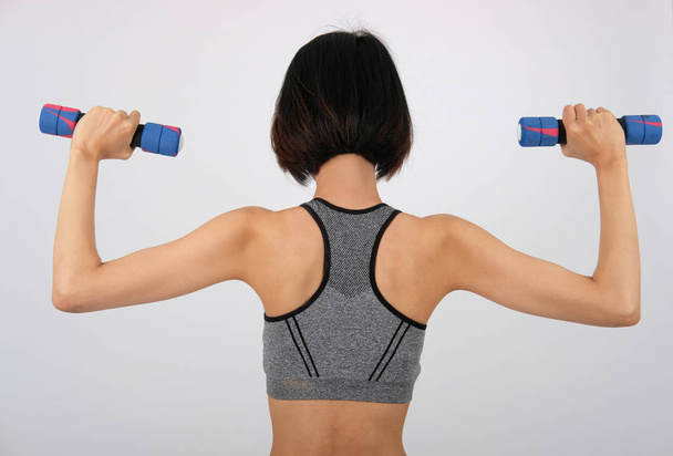 sporty woman in sportswear with dumbbell doing fitness workout o - 写真・画像