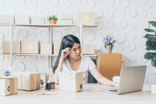 Asian Women business owner working at home with packing box on w - Fotó, kép