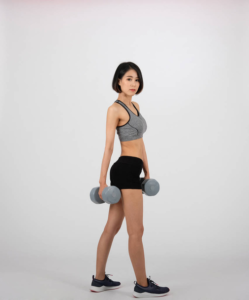 mulher desportiva em sportswear com halteres fazendo exercício de fitness o
 - Foto, Imagem