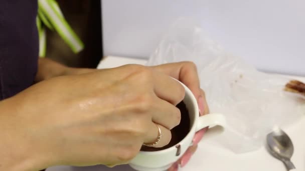Woman dipping dark chocolate biscuit cookies. - Materiał filmowy, wideo