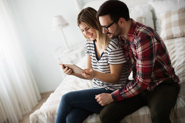 Attractive young couple in love using digital tablet - Фото, изображение