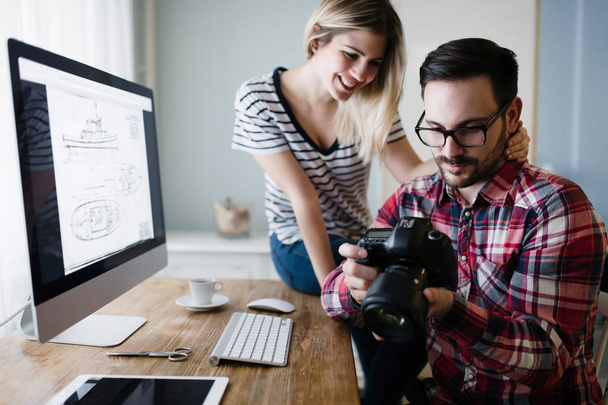 Beautiful woman and attractive man doing design work on computer - Photo, image