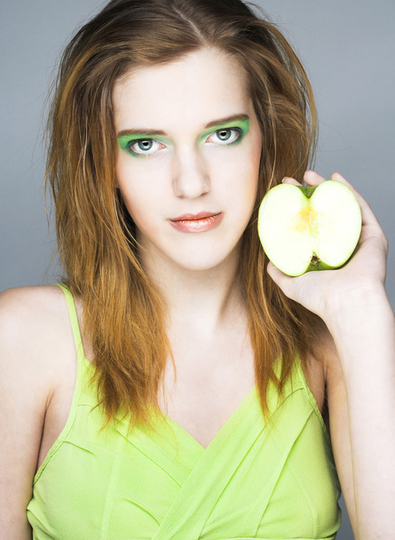 Young woman with green apple - Фото, изображение