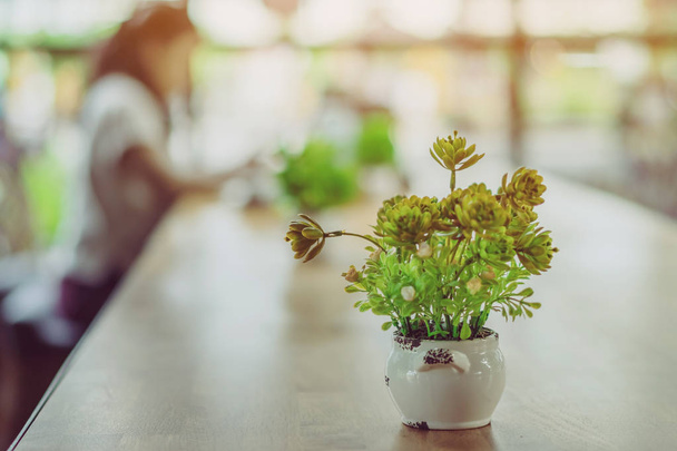 Plantes artificielles ou arbre en plastique sur la table pour la décoration et bienvenue pour les clients dans le café. - Photo, image