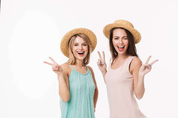 Two cheerful young girls wearing summer clothes - Фото, изображение
