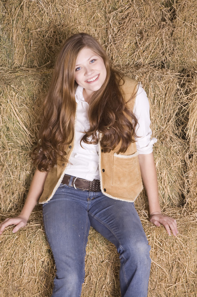 Woman sitting on haystack happy - Φωτογραφία, εικόνα