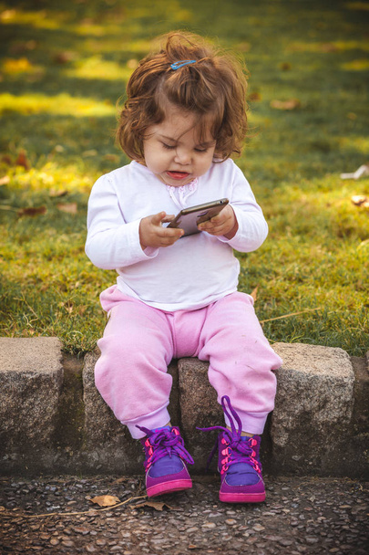 baby with mobile in park - Фото, изображение