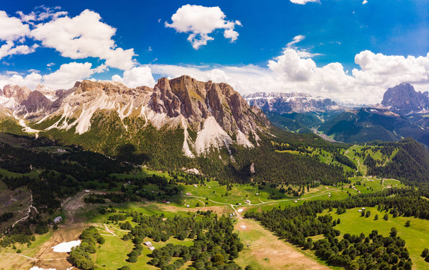 Aerial top view from drone to Col Raiser plateau In sunny summer Day. Scenery of rugged Sella Mountain with green valley on grassy hillside village St. Cristina di Val Gardena, Bolzano, Seceda Italy. - Photo, Image