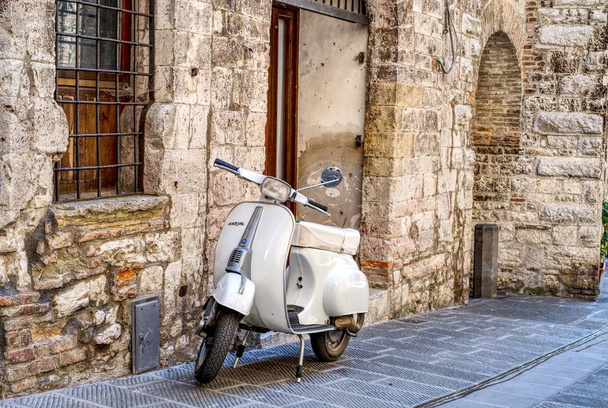 Gubbio, Italy - 11 August, 2019: Old Italian scooter parked in a street of the city of Gubbio, Umbria - Valokuva, kuva