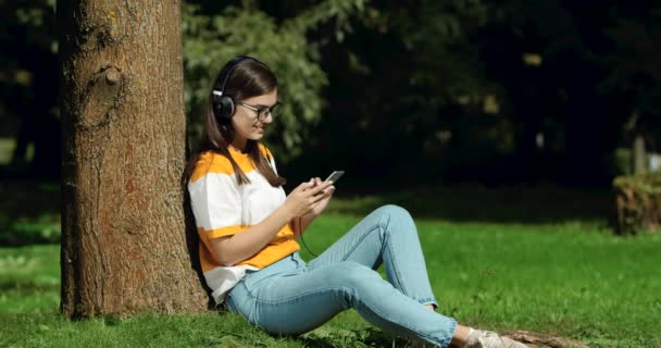 Woman in Headphones Listening to Music - Záběry, video