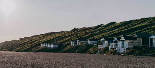 Beach huts during sunset in Milford on Sea, Hampshire, UK. - Foto, Imagen