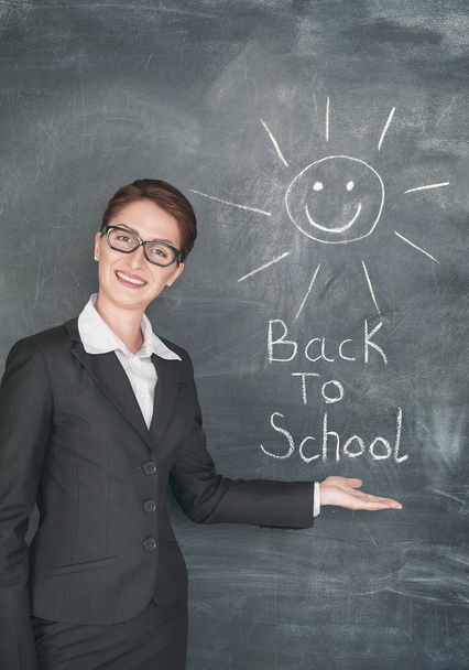 Happy teacher and smiling sun on the chalkboard - Photo, image