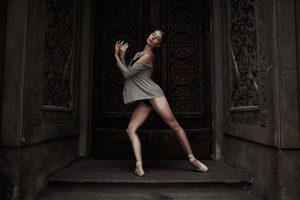 Young and graceful ballerina performing on the street - Photo, image