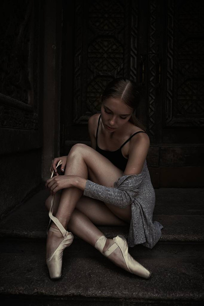 Young and graceful ballerina performing on the street - Foto, immagini