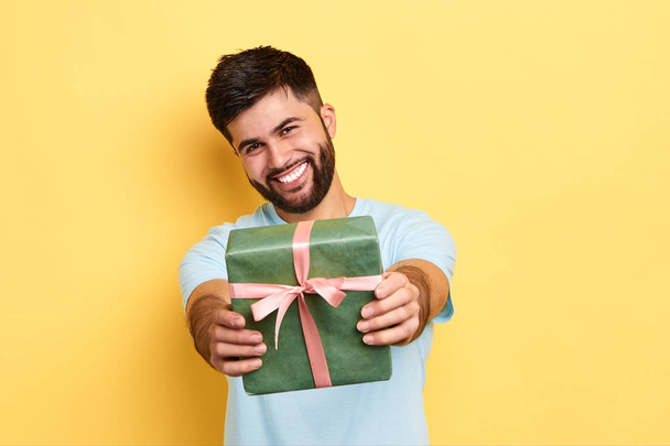 cheerful positive kind man giving a present to a friend - Foto, imagen