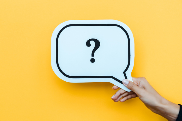 cropped view of woman holding speech bubble with question mark on orange  - Photo, Image