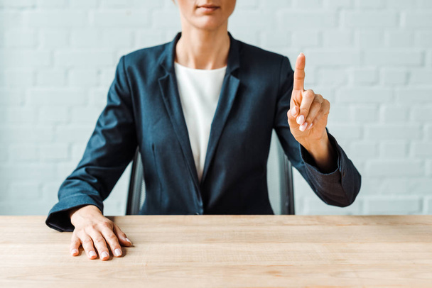 cropped view of businesswoman pointing with finger in office  - Valokuva, kuva