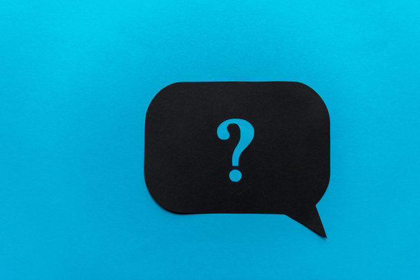 top view of of black question mark on speech bubble isolated on blue  - Photo, Image