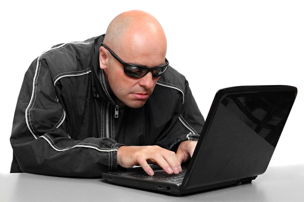 Un hacker pericoloso con un portatile. Concetto sicurezza dei dati
 - Foto, immagini
