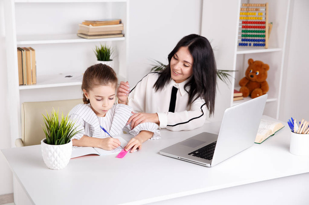 Home education concept. Tutor and girl doing homework together. - Foto, Imagen