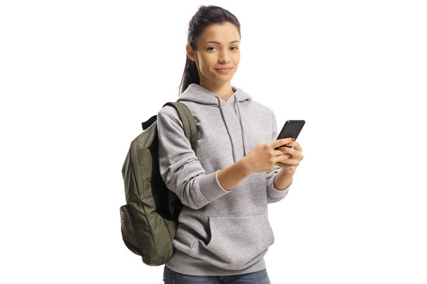 Cheerful female student holding a mobile phone and looking at th - Fotografie, Obrázek