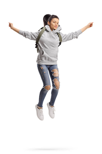 Female student with backpack jumping - Φωτογραφία, εικόνα