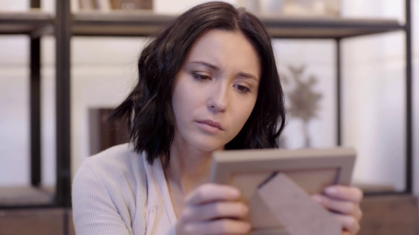 selective focus of woman looking at photo frame  - Footage, Video