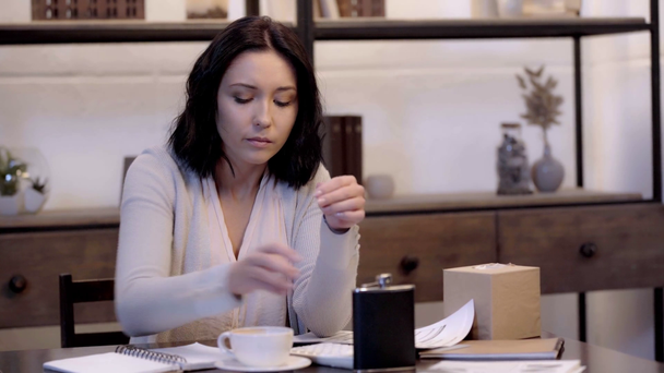 upset woman drinking coffee and holding papers   - Séquence, vidéo
