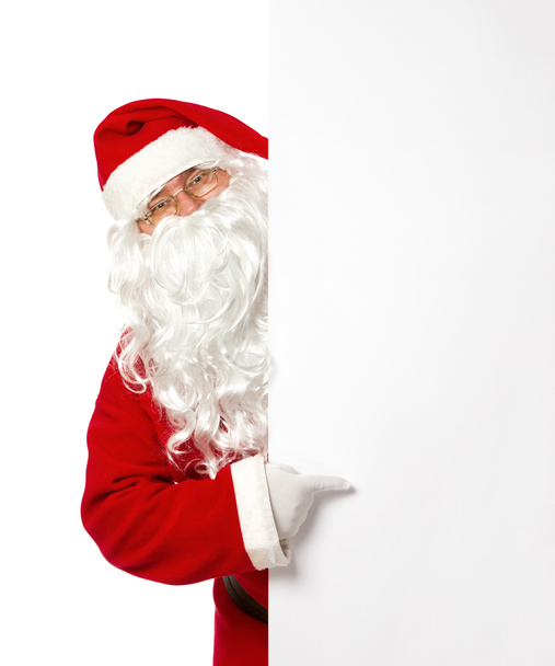 Santa Claus pointing on a blank banner - Photo, Image