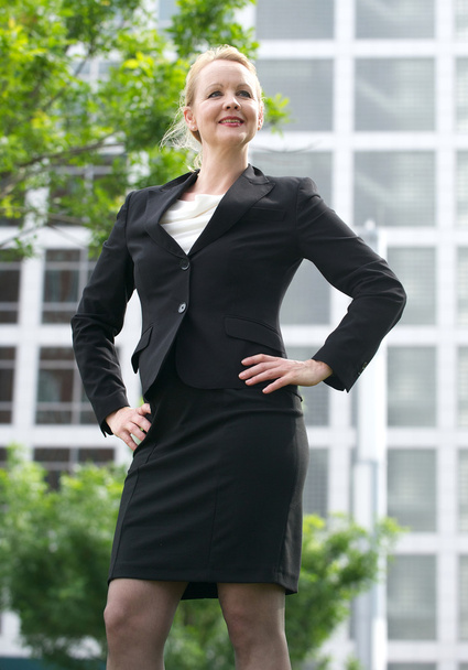 Happy businesswoman standing in the city - Photo, image