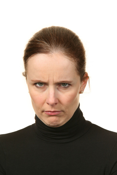 Close-up portrait of a young woman doing a pout expression, over a white background - Foto, Imagem