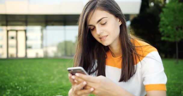 Smiling Woman Texting on Smartphone - Кадри, відео