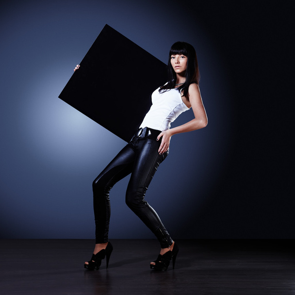 Stylish young lady holding blank board - Fotoğraf, Görsel