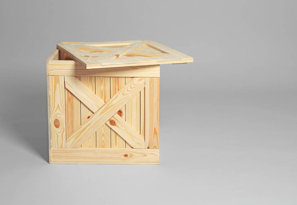 Open wooden crate on grey background. Space for text - Φωτογραφία, εικόνα